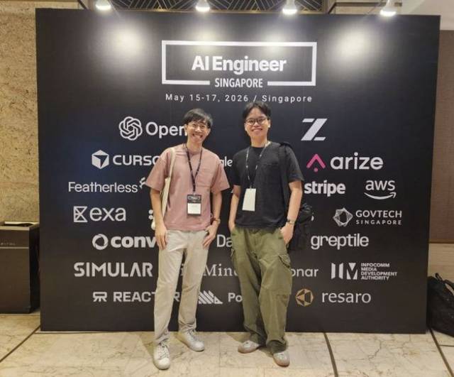 Lance with another attendee in front of the AI Engineer Singapore 2026 event backdrop.